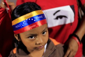 Young supporter of Venezuela's President Chavez stands at a square in San Salvador
